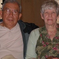 Gray-haired man and woman sitting side by side